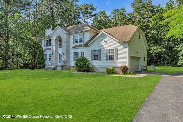 3688 Ridgeway Rd, Manchester, NJ 08759 - colonial home featuring driveway, an attached garage, a chimney, and a front yard