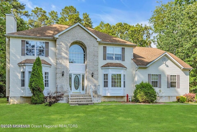 3688 Ridgeway Rd, Manchester, NJ 08759 - view of front of house with a chimney, a front yard, and a shingled roof