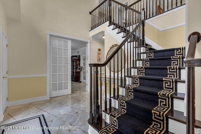 3688 Ridgeway Rd, Manchester, NJ 08759 - staircase featuring marble tiled floors, a high ceiling, baseboards, and french doors