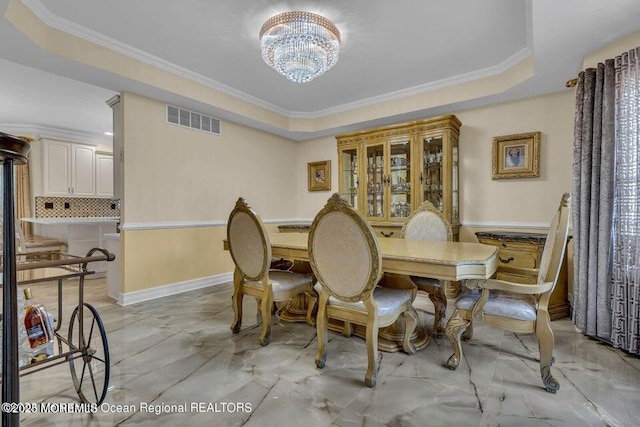 3688 Ridgeway Rd, Manchester, NJ 08759 - dining space featuring light marble finish floors, a chandelier, a raised ceiling, and ornamental molding