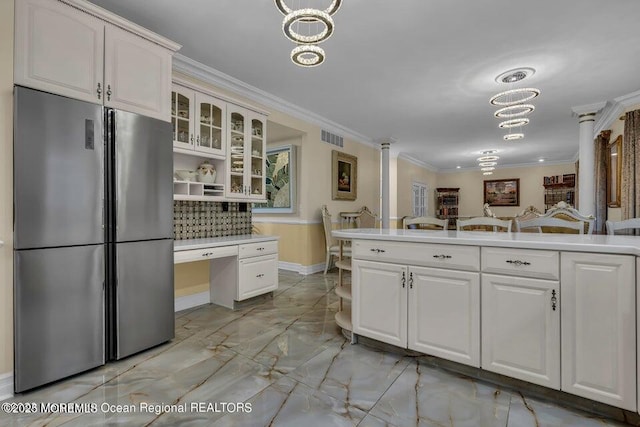 3688 Ridgeway Rd, Manchester, NJ 08759 - kitchen featuring freestanding refrigerator, light marble finish floors, crown molding, light countertops, and glass insert cabinets