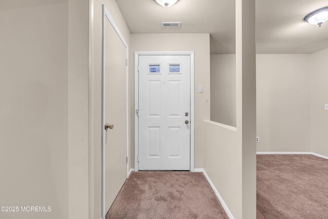 doorway to outside with carpet and baseboards