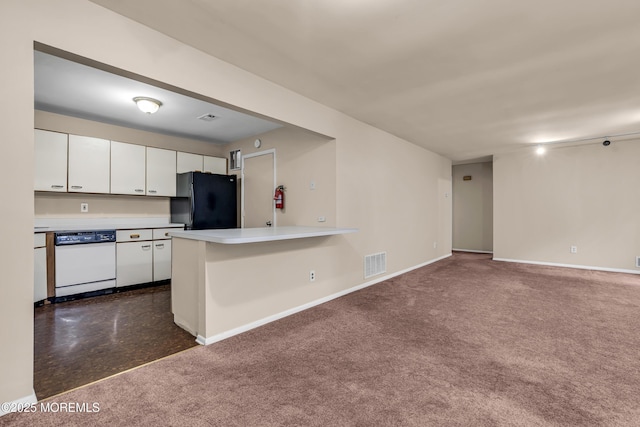 kitchen featuring dishwasher, freestanding refrigerator, white cabinets, baseboards, and light countertops