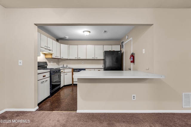kitchen with black appliances, under cabinet range hood, a peninsula, light countertops, and white cabinetry