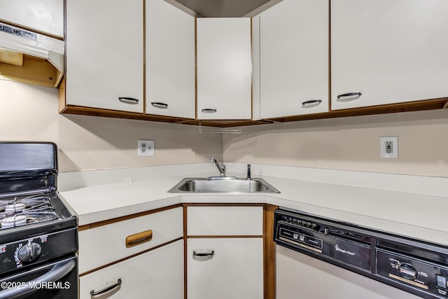 kitchen featuring dishwasher, black range with gas cooktop, a sink, white cabinetry, and under cabinet range hood