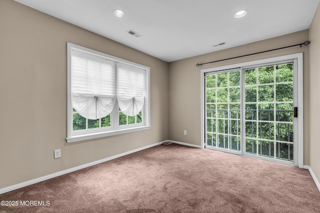 empty room featuring carpet flooring, baseboards, healthy amount of natural light, and recessed lighting