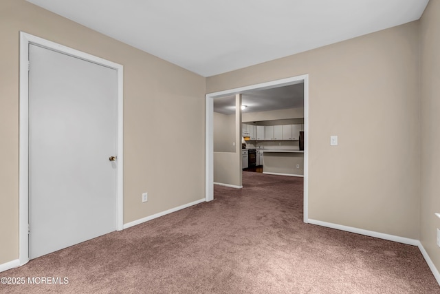 carpeted empty room with baseboards