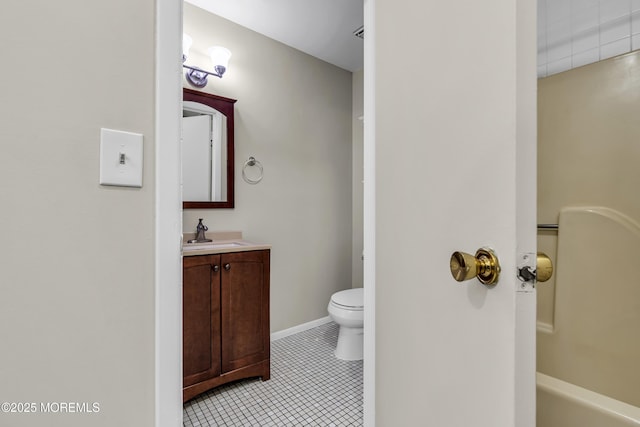 bathroom with toilet, vanity, tile patterned flooring, and a bathtub