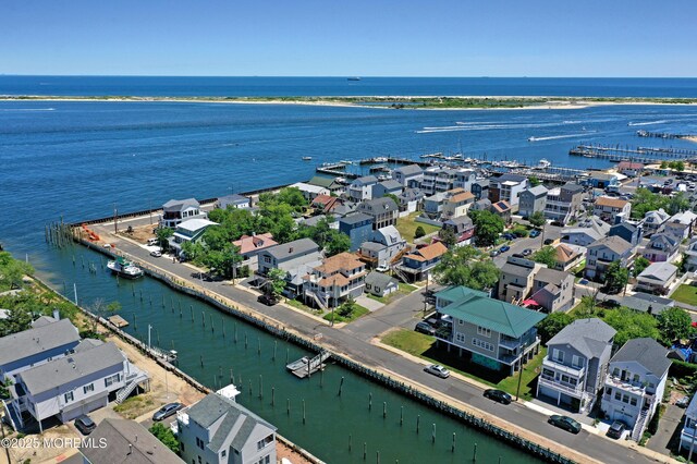 aerial perspective of suburban area with a nearby body of water