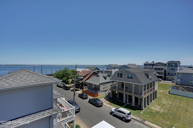aerial perspective of suburban area with a nearby body of water