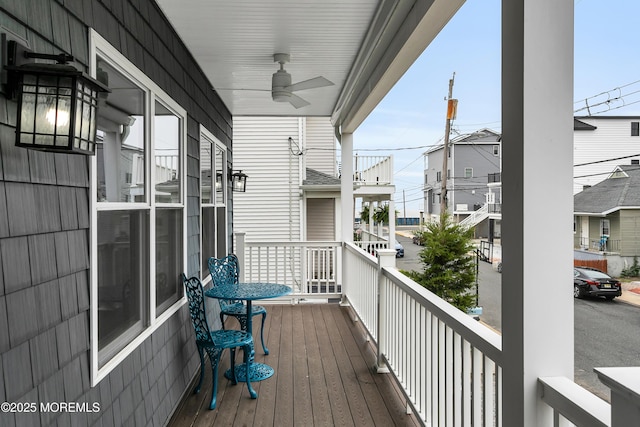 deck featuring a ceiling fan and a residential view