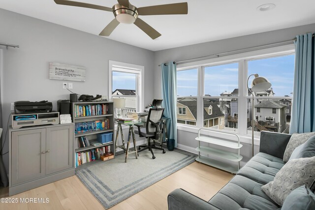 office with a ceiling fan and light wood-style floors