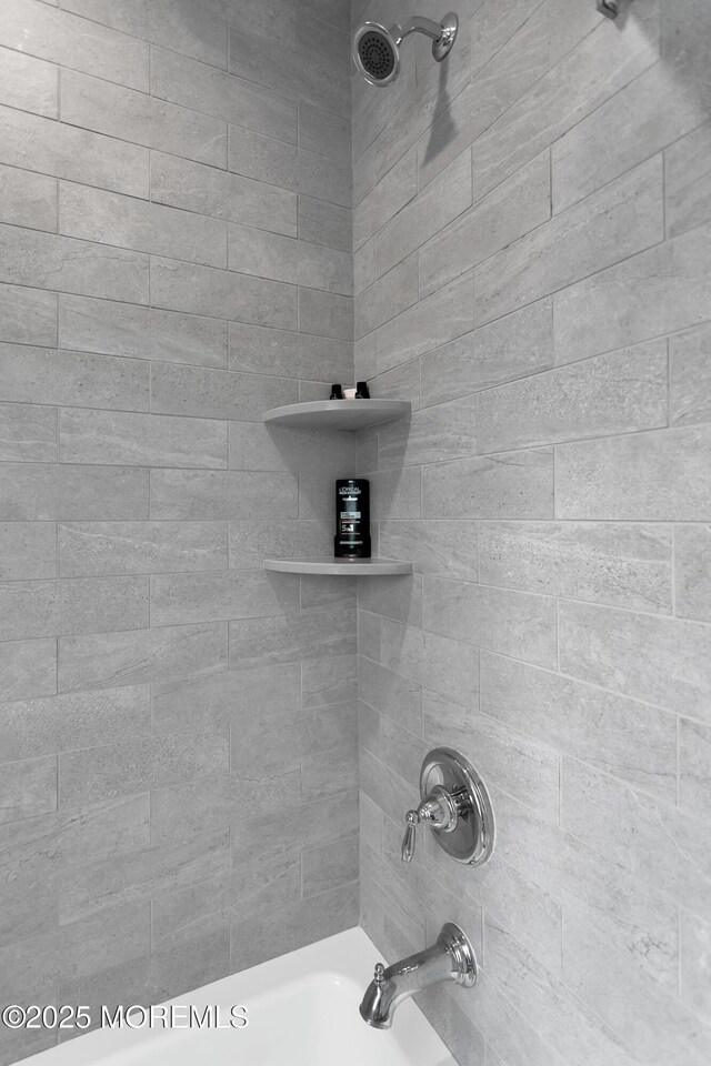 bathroom view of shower / bathtub combination