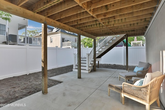 view of patio / terrace featuring stairway and a fenced backyard