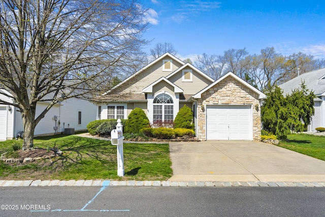 12 Rye Ct, Jackson, NJ 08527 - view of front facade featuring a front lawn, stone siding, central air condition unit, and a garage