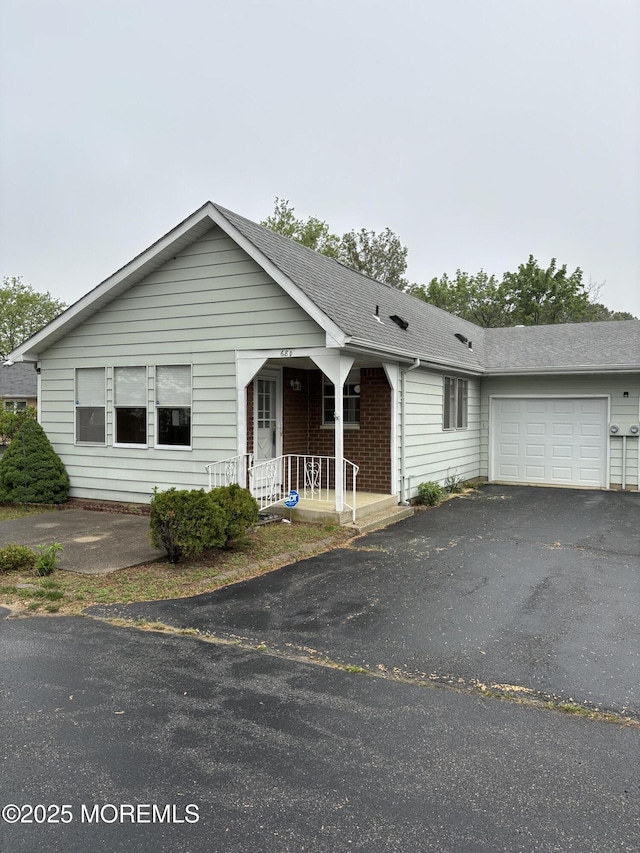 68D Yorktowne Pkwy, Whiting, NJ 08759 - ranch-style house with a porch, a garage, a shingled roof, and driveway