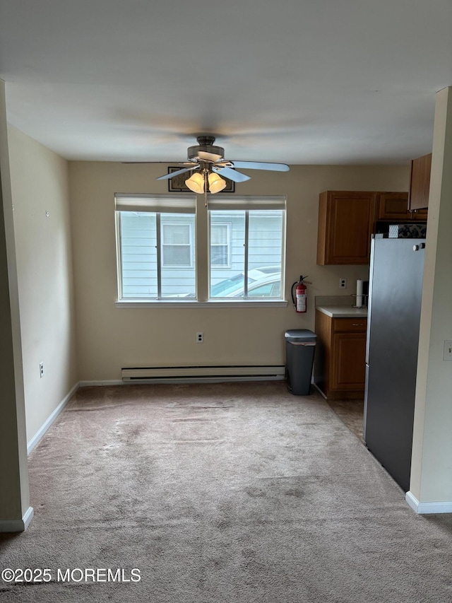 68D Yorktowne Pkwy, Whiting, NJ 08759 - kitchen featuring brown cabinets, freestanding refrigerator, a baseboard radiator, light carpet, and ceiling fan