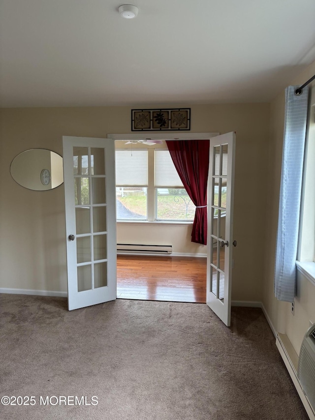 68D Yorktowne Pkwy, Whiting, NJ 08759 - carpeted empty room featuring baseboards, french doors, and a baseboard radiator
