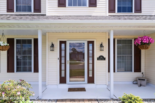 view of exterior entry with covered porch