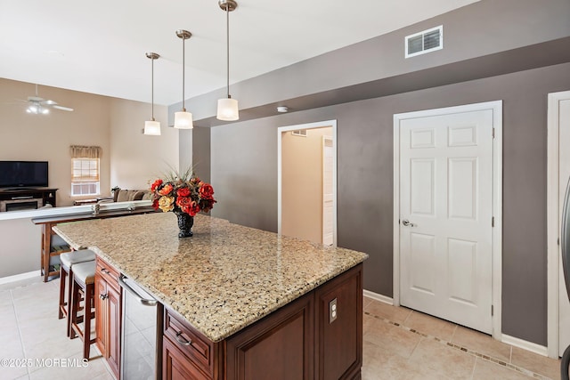 kitchen with light tile patterned floors, baseboards, light stone countertops, and ceiling fan
