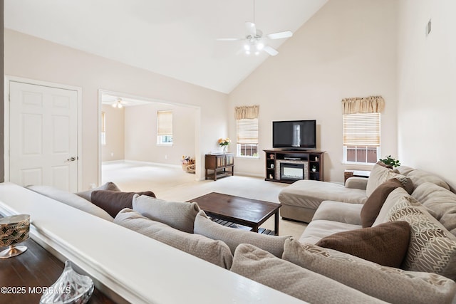 carpeted living area featuring high vaulted ceiling, ceiling fan, and baseboards