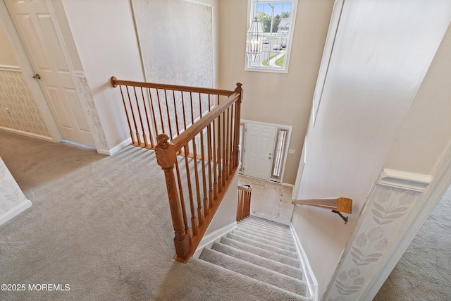 stairs with carpet flooring and baseboards