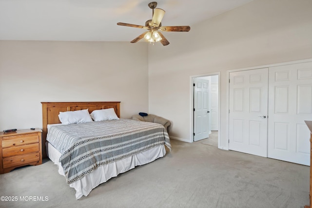 bedroom with light carpet, high vaulted ceiling, a closet, and a ceiling fan