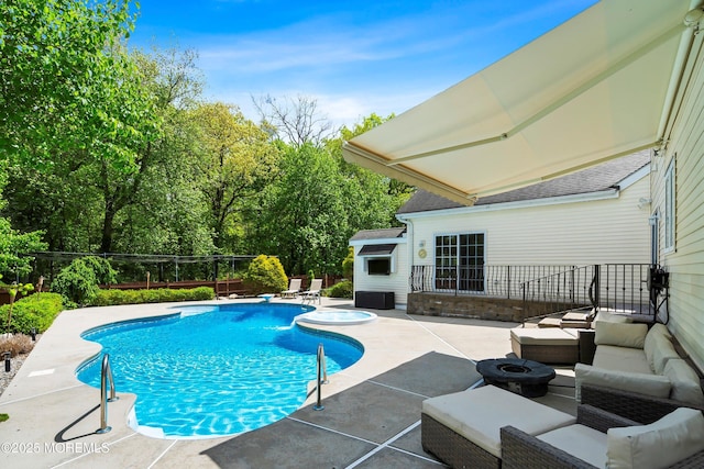 view of swimming pool with a patio, an outdoor living space with a fire pit, and a fenced backyard