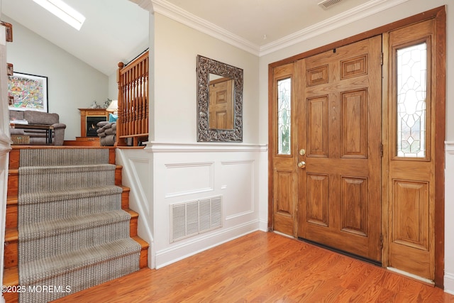 2 Nassau Pl, Middletown, NJ 07748 - foyer featuring light wood-type flooring, wainscoting, stairs, crown molding, and lofted ceiling