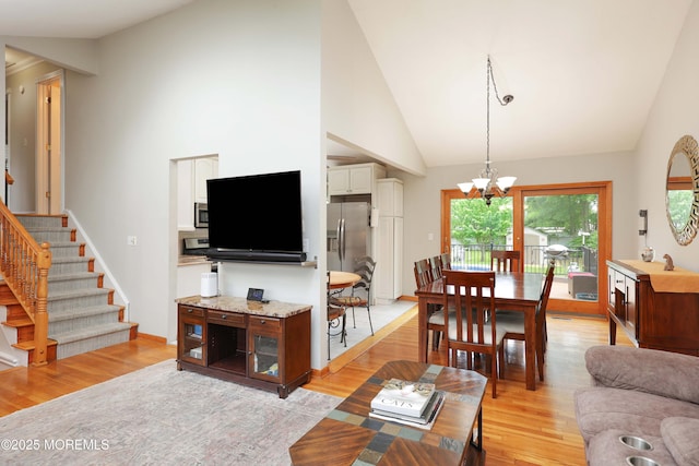 2 Nassau Pl, Middletown, NJ 07748 - living area featuring light wood-type flooring, a chandelier, stairs, high vaulted ceiling, and baseboards