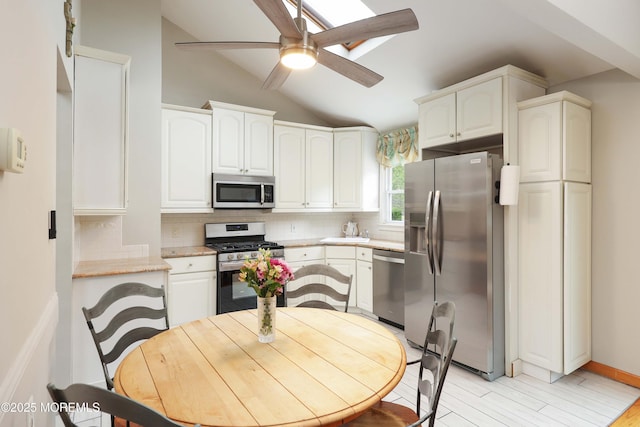 2 Nassau Pl, Middletown, NJ 07748 - kitchen with appliances with stainless steel finishes, vaulted ceiling, backsplash, ceiling fan, and white cabinets