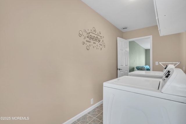laundry area with independent washer and dryer and baseboards