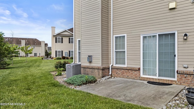 43 Morgan Way Unit 43, Monroe, NJ 08831 - back of property with a patio, brick siding, central AC unit, and a lawn