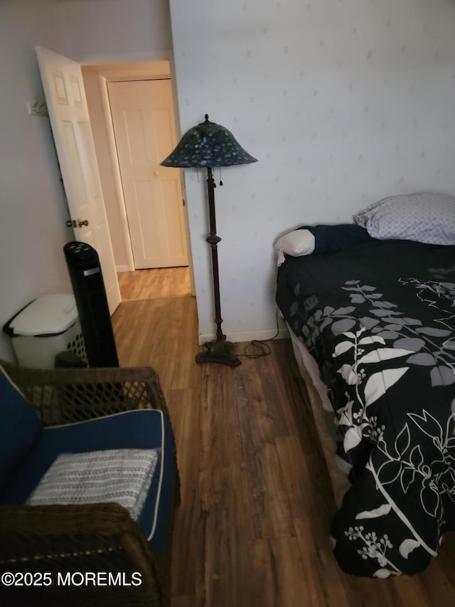 bedroom with wood finished floors and baseboards