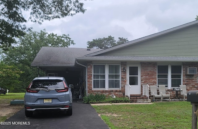 11B Walnut Rd, Manahawkin, NJ 08050 - view of front of house featuring brick siding, a front yard, a carport, and asphalt driveway