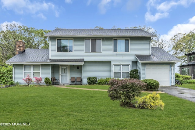 1584 Alamitos Dr, Lakewood, NJ 08701 - traditional home with a chimney, a shingled roof, aphalt driveway, and a front lawn