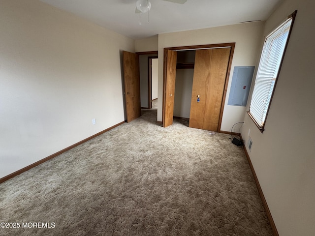 unfurnished bedroom with light carpet, a closet, and electric panel