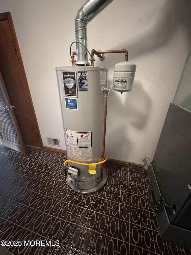 utility room featuring visible vents and gas water heater