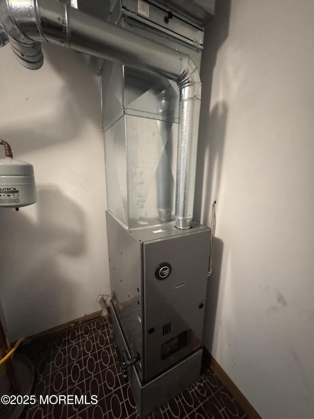 utility room featuring heating unit