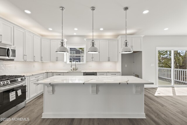 204 Morningside Ave, Union Beach, NJ 07735 - kitchen with stainless steel appliances, a center island, light wood-style flooring, decorative backsplash, and recessed lighting