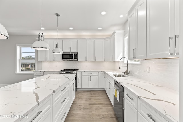 204 Morningside Ave, Union Beach, NJ 07735 - kitchen featuring stainless steel microwave, a sink, dishwasher, white cabinets, and light wood-style floors