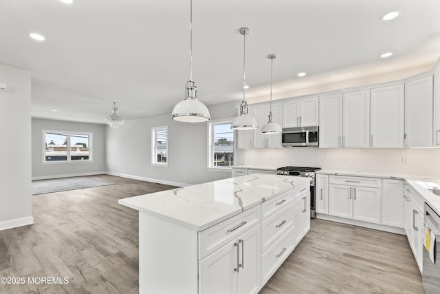 204 Morningside Ave, Union Beach, NJ 07735 - kitchen with stainless steel appliances, recessed lighting, a kitchen island, healthy amount of natural light, and light wood-style floors
