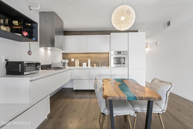 138 Bodman Pl Unit 5, Red Bank, NJ 07701 - kitchen featuring stainless steel appliances, dark wood-type flooring, white cabinets, and light countertops