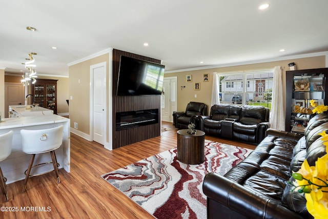 131 Locust St, Tuckerton, NJ 08087 - living room featuring a large fireplace, wood finished floors, ornamental molding, and recessed lighting