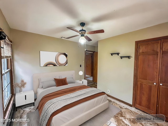 bedroom with ceiling fan and baseboards