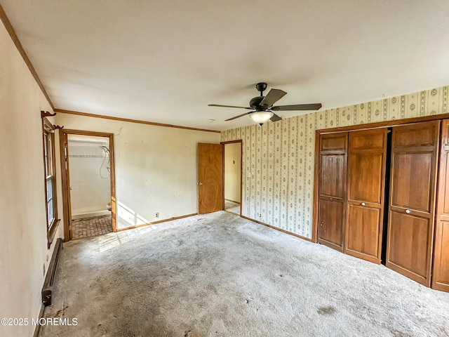 unfurnished bedroom featuring baseboards, crown molding, wallpapered walls, and carpet floors