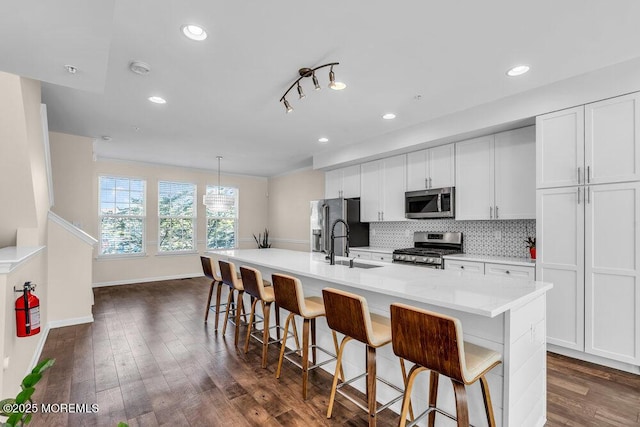 600 Grand Ave Unit 7C, Asbury Park, NJ 07712 - kitchen featuring appliances with stainless steel finishes, a sink, a kitchen island with sink, a breakfast bar, and tasteful backsplash