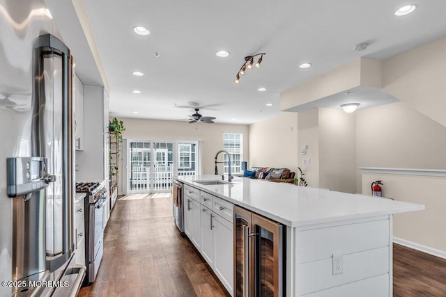 600 Grand Ave Unit 7C, Asbury Park, NJ 07712 - kitchen featuring a sink, appliances with stainless steel finishes, wine cooler, white cabinetry, and a ceiling fan