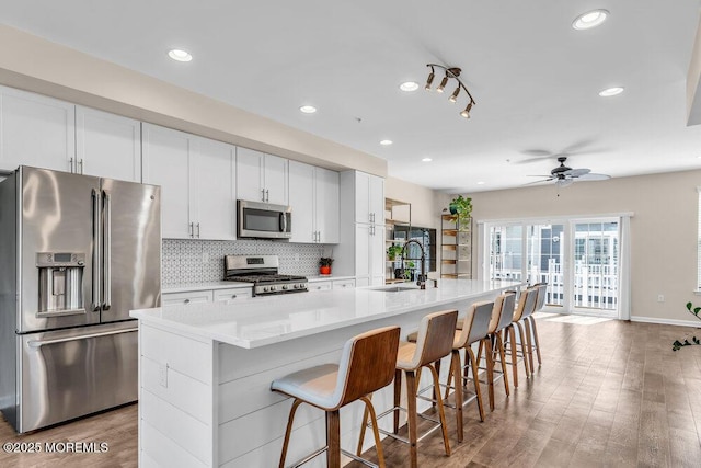 600 Grand Ave Unit 7C, Asbury Park, NJ 07712 - kitchen with appliances with stainless steel finishes, a sink, a large island with sink, tasteful backsplash, and ceiling fan