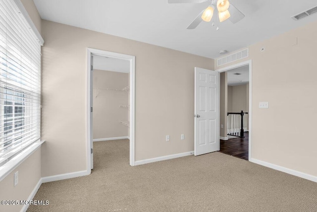 600 Grand Ave Unit 7C, Asbury Park, NJ 07712 - unfurnished bedroom featuring carpet flooring, baseboards, a walk in closet, a closet, and a ceiling fan